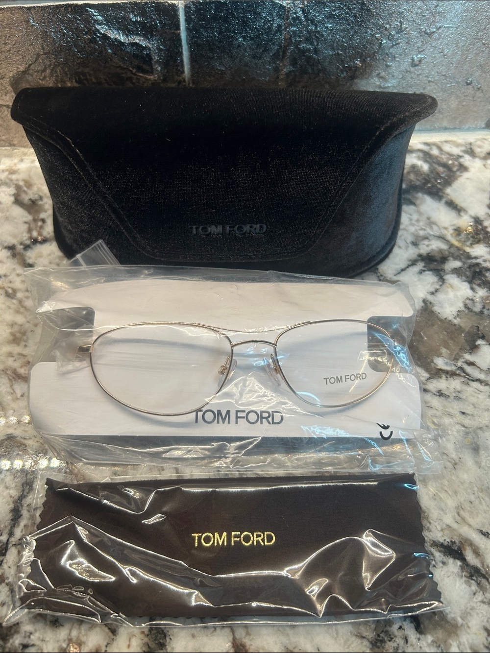 Tom Ford Gold Metal Oval Eyeglasses with Black Accessories